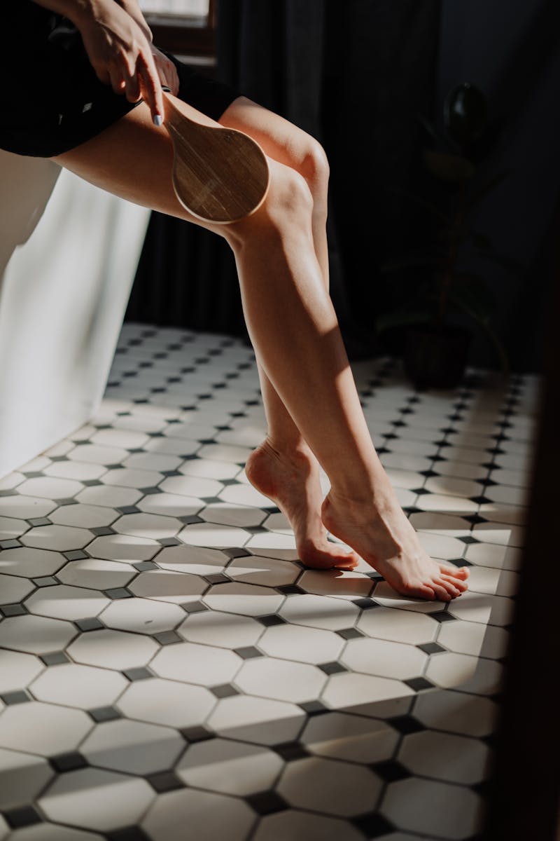 A young woman indulges in a serene beauty routine, highlighting natural elegance.