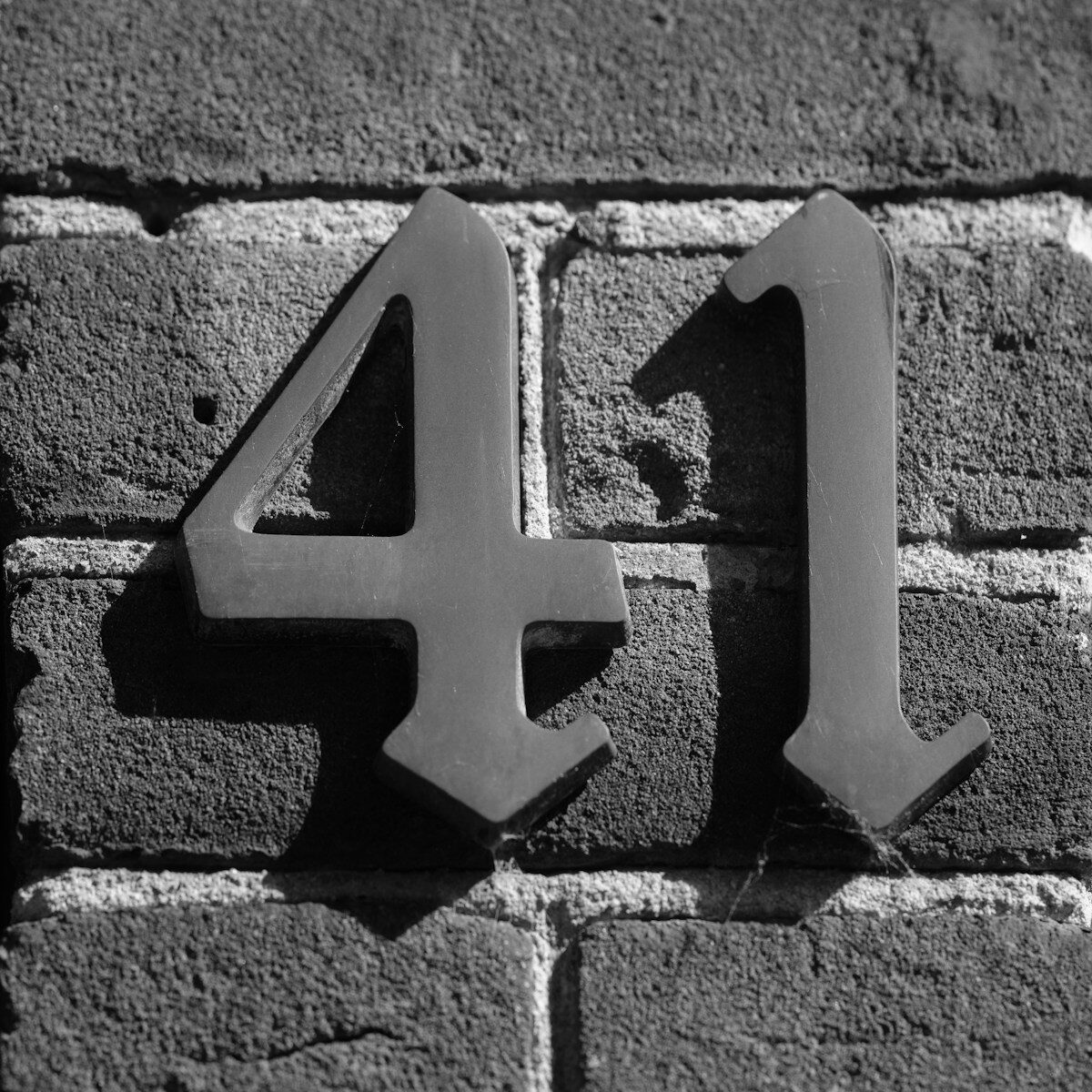 The number "41" is mounted on a brick wall.
